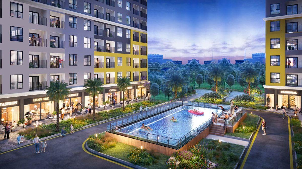 Hồ bơi nội khu Bcons Central Park kết hợp cảnh quan xanh và các block căn hộ.